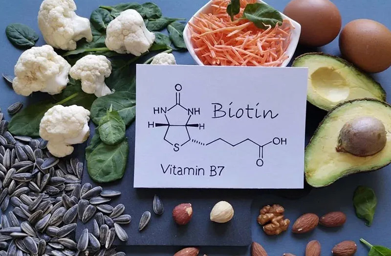 Biotin capsules and a lush backdrop of vibrant, healthy hair, portraying the impact of this essential vitamin on hair strength and growth.